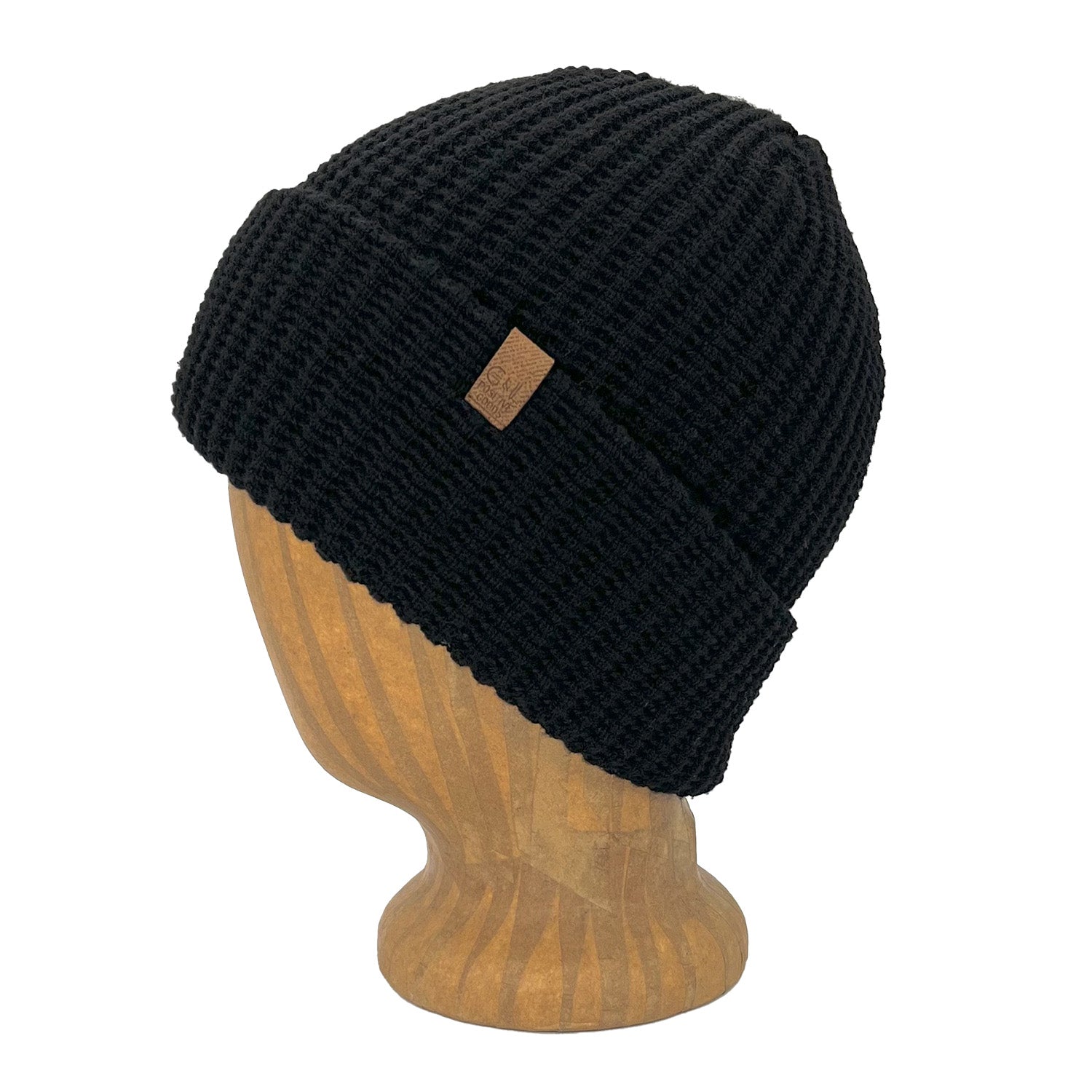 Black knit beanie with a brown label on a wooden mannequin head against a white background
g-and-l-positive-goods-kayo-beanie-left-side