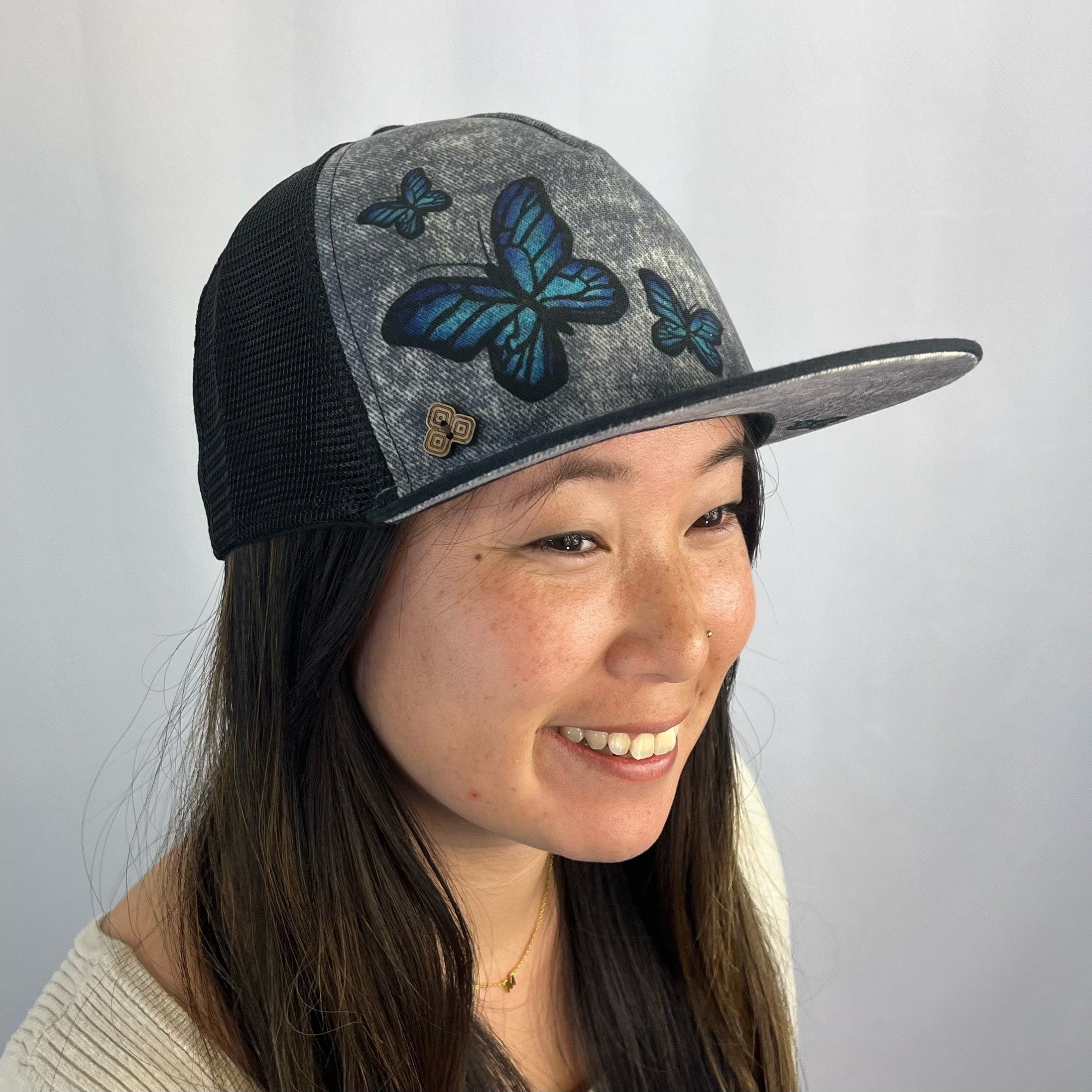 Mariposa Hat on female model – artistic butterfly mesh cap made with sustainable materials