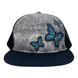 Mariposa Trucker Hat front view – butterfly print 5 panel mesh cap made from recycled materials