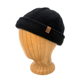 Black beanie on a wooden mannequin head with a visible brand logo against a white background
g-and-l-positive-goods-shorty-brimless-cap-left-side