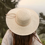 Yoko Sun Hat back top view on female model – feather-light SPF straw hat for summer wear