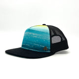 Side profile of the Atlantis Trucker Hat, showing its structured fit, adjustable snapback, and eco-friendly materials.