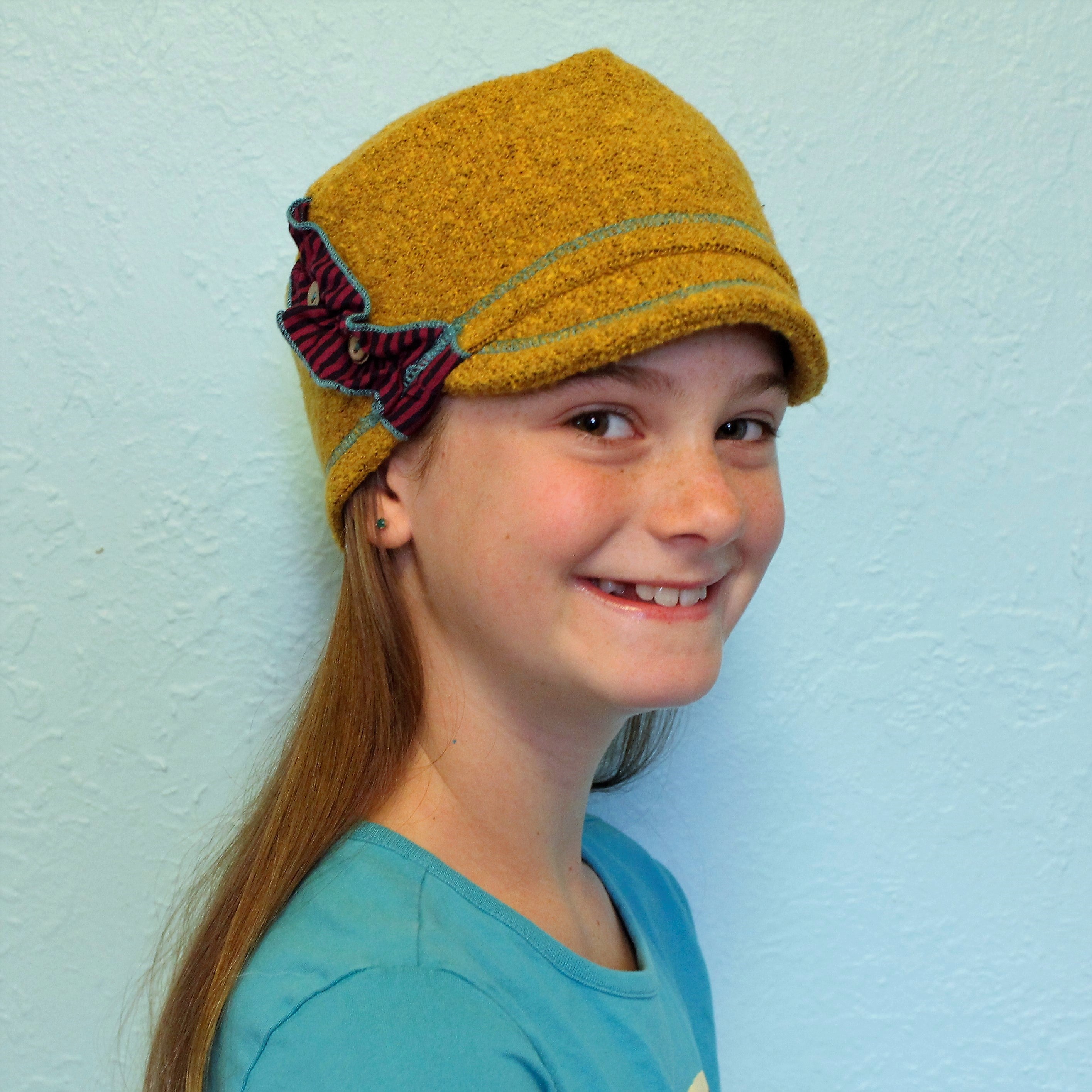 Dalia Kids Soft Cap in yellow dijon color on girl model – recycled cotton fashion