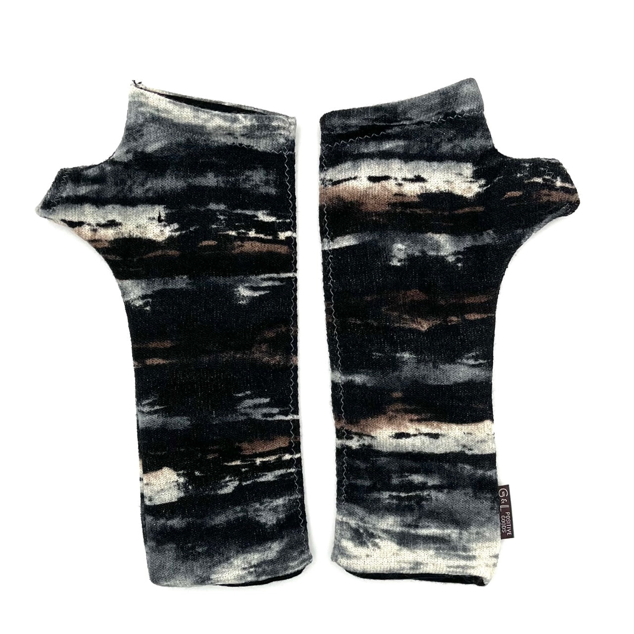 Gemini Wrist Warmers in abstract colorway of black, brown, white, blue, grey – front view showing lined upcycled cotton jersey fabric
