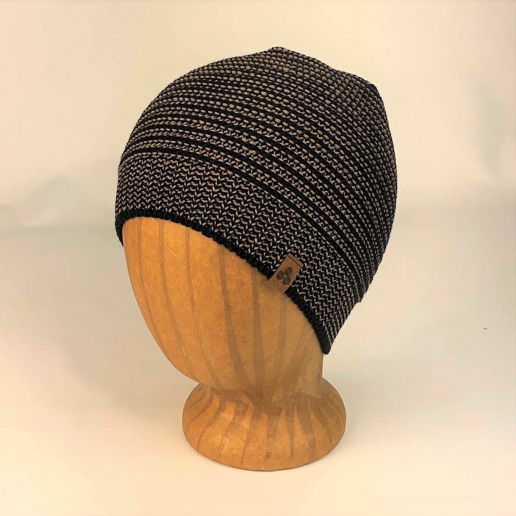 Kids Bigfoot Beanie in mirage oak color way on wood head block, profile view