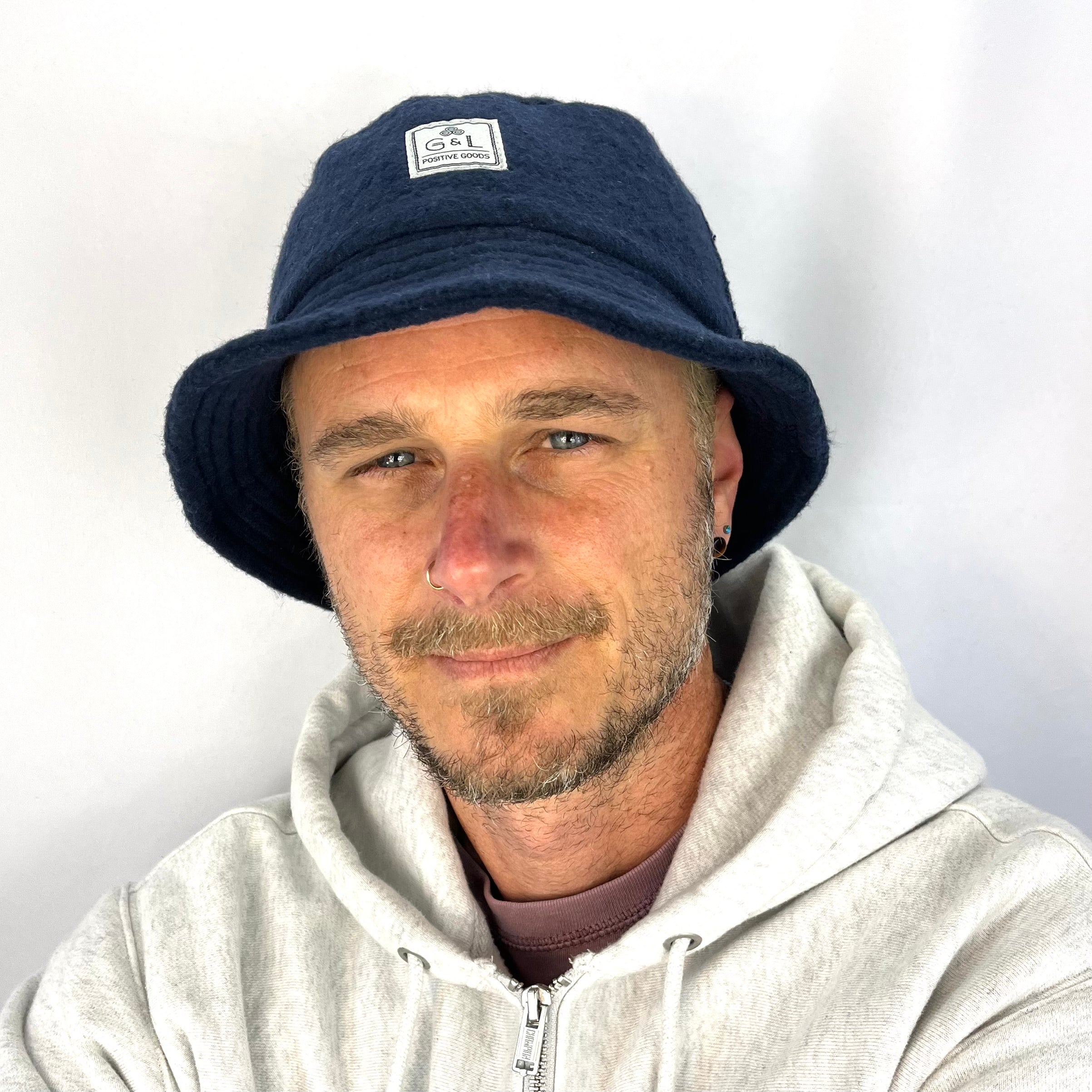 Taylor Bucket Hat in dark navy blue on male model front view – co-gender eco-friendly soft cap
