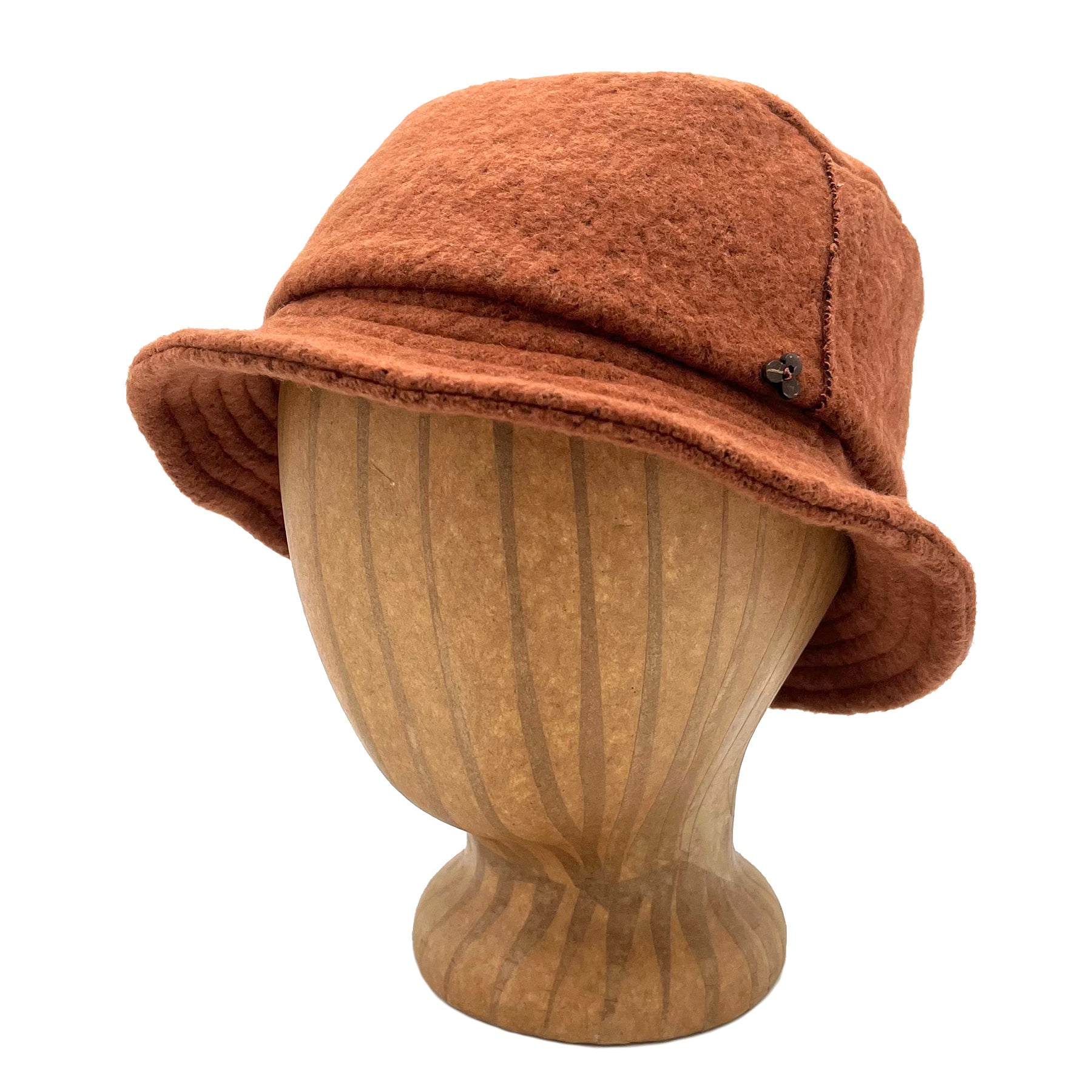 Taylor Bucket Hat in orange nutmeg color front view on wooden head block – eco-friendly recycled cotton soft cap