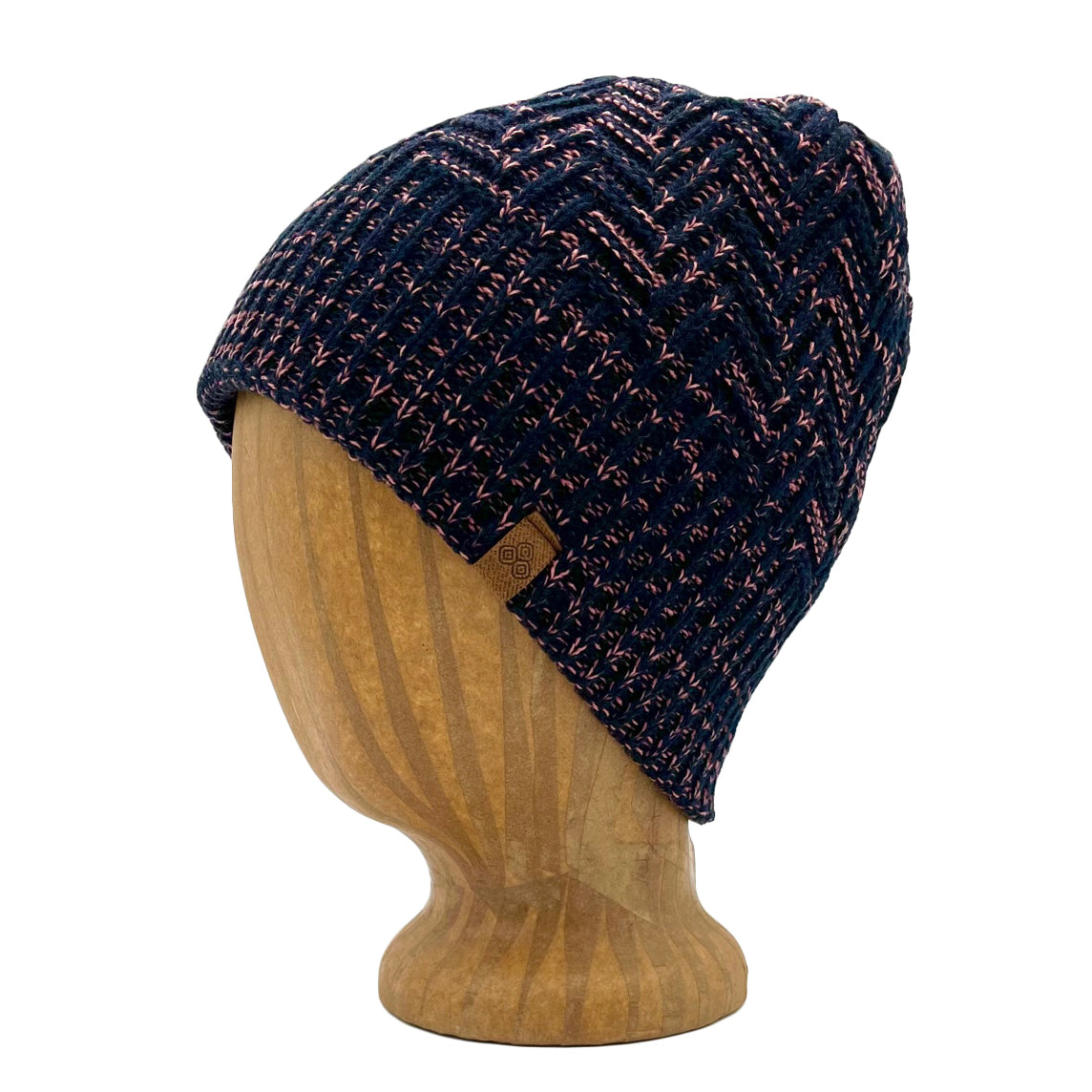 Venice Beanie in Rose Burst color – worn on wooden head block.