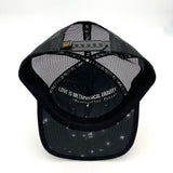 Underside view of the Visions Cosmos Trucker Hat, showing foam visor, organic cotton brim, and packable construction.