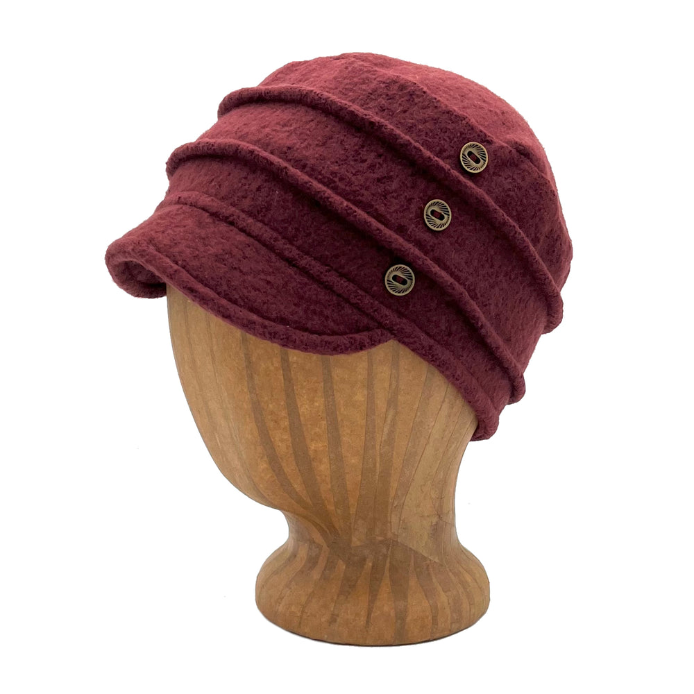 Short brim soft cap. Feminine fit with embellished pin tucks and metal buttons. Made in the USA from upcycled cotton. *marsala