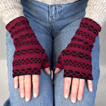 Aspen Wrist Warmers on female model – upcycled knit wrist warmers - burgundy gloves with black cut outs