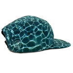 Blue water patterned flat bill snap back eco-friendly recycled polyester camp hat side view.