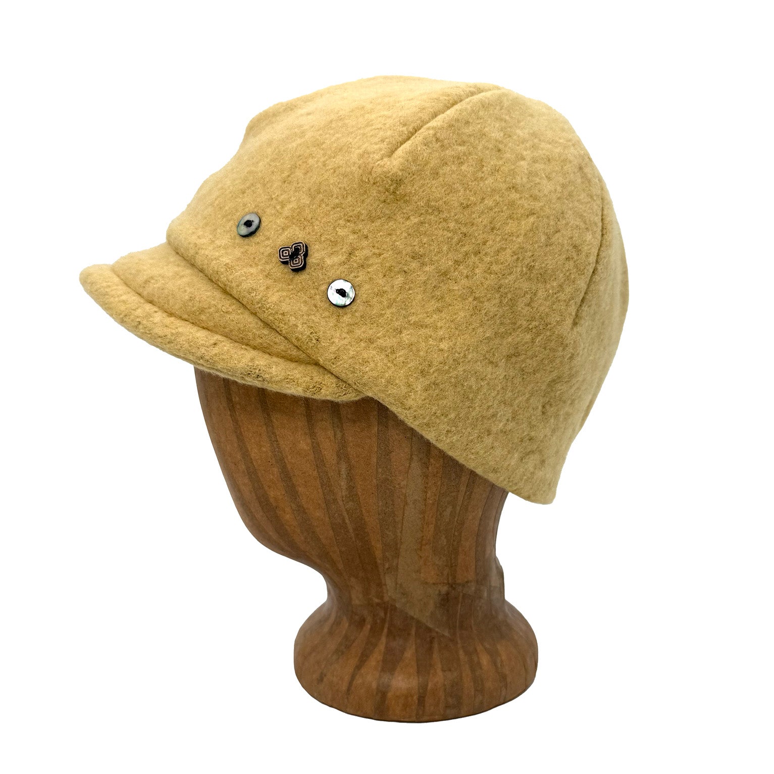 Yellow cap on a wooden mannequin head against a white background  g-and-l-positive-goods-camden-cap-left-side