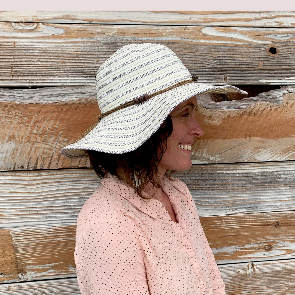 Profile shot of female model wearing the Katya Sun Hat on a sunny day.