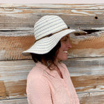 Profile shot of female model wearing the Katya Sun Hat on a sunny day.