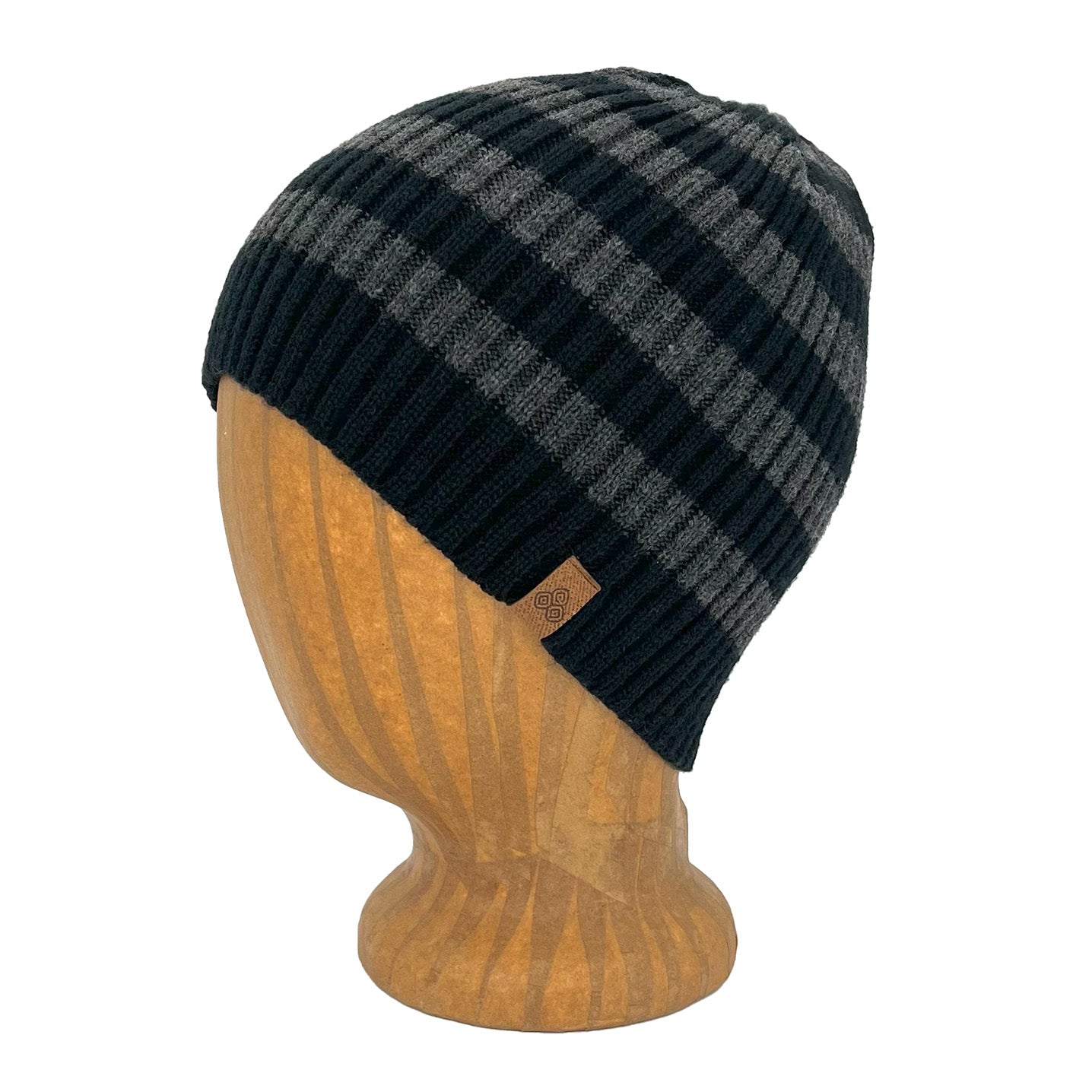 Black and gray checkered beanie on a wooden mannequin head against a white background Lucky Beanie left side view – stretchy striped recycled knit hat