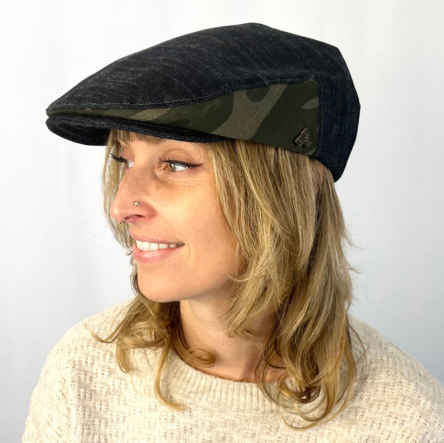 Matisse Flat Cap side view on female – upcycled black denim flat cap with camo detail