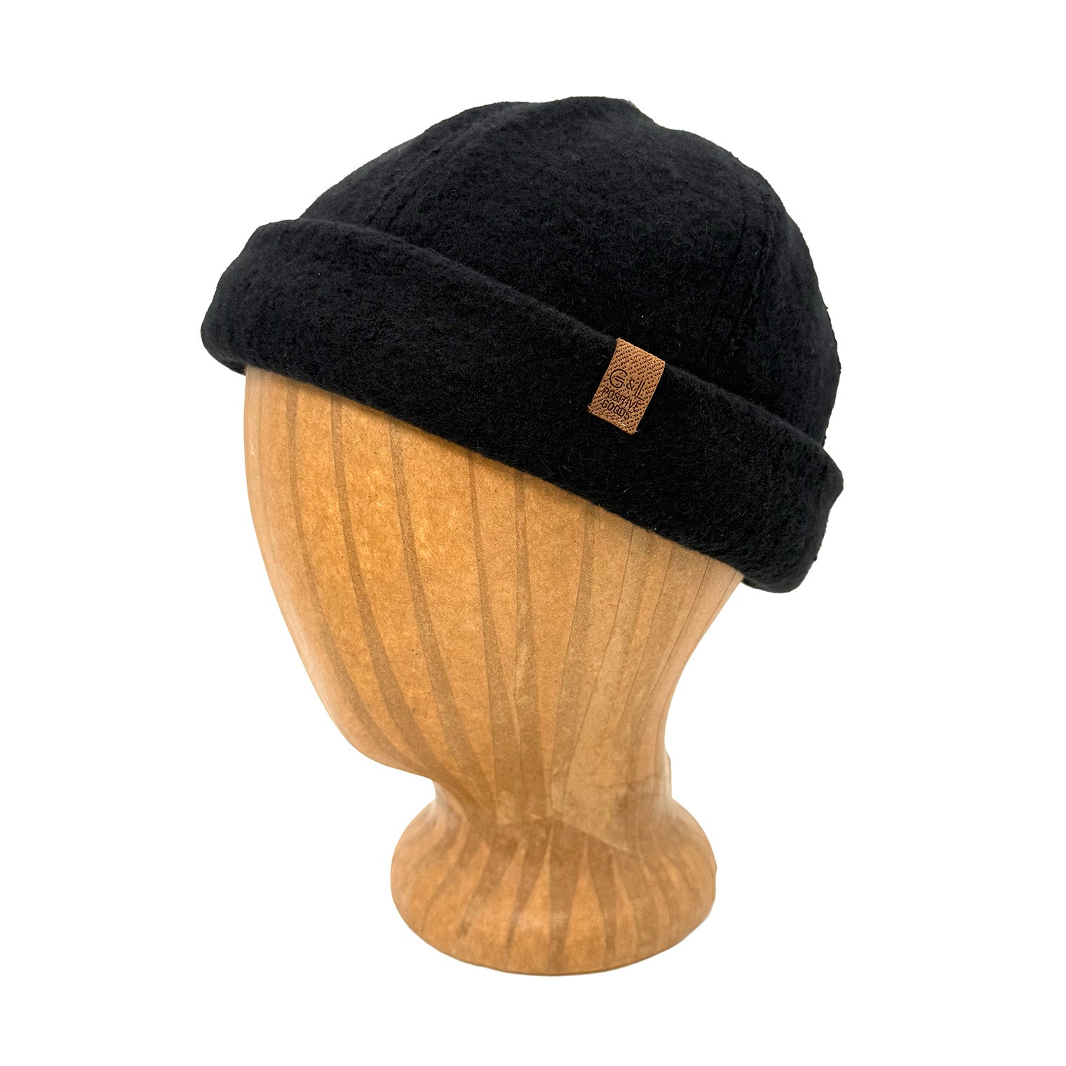 Black beanie on a wooden mannequin head with a visible brand logo against a white background
g-and-l-positive-goods-shorty-brimless-cap-left-side