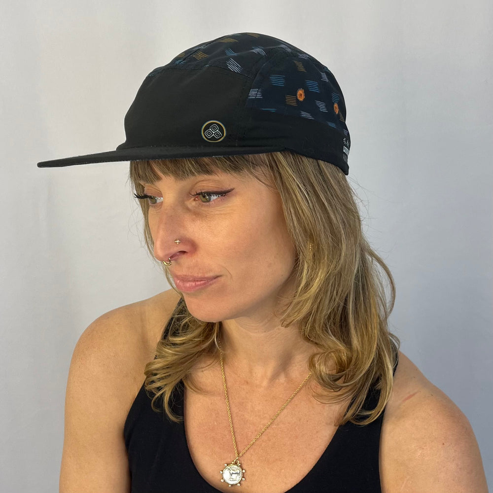Wanderlust Lines Hat female model wearing Wanderlust Lines recycled 5-panel hat