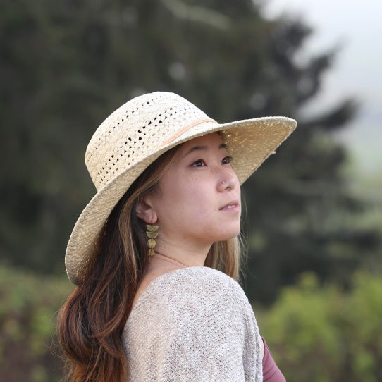 Yoko Sun Hat side view on female model – feather-light SPF straw hat for summer wear