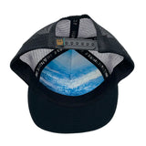 Underside view of the Zuma Azure Trucker Hat with hand-loomed cotton, faux suede visor, and adjustable mesh snapback.