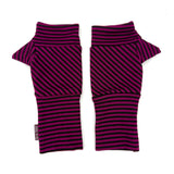 A pair of fingerless knit wrist warmers with diagonal dark pink and black stripes, laid flat on a white background.