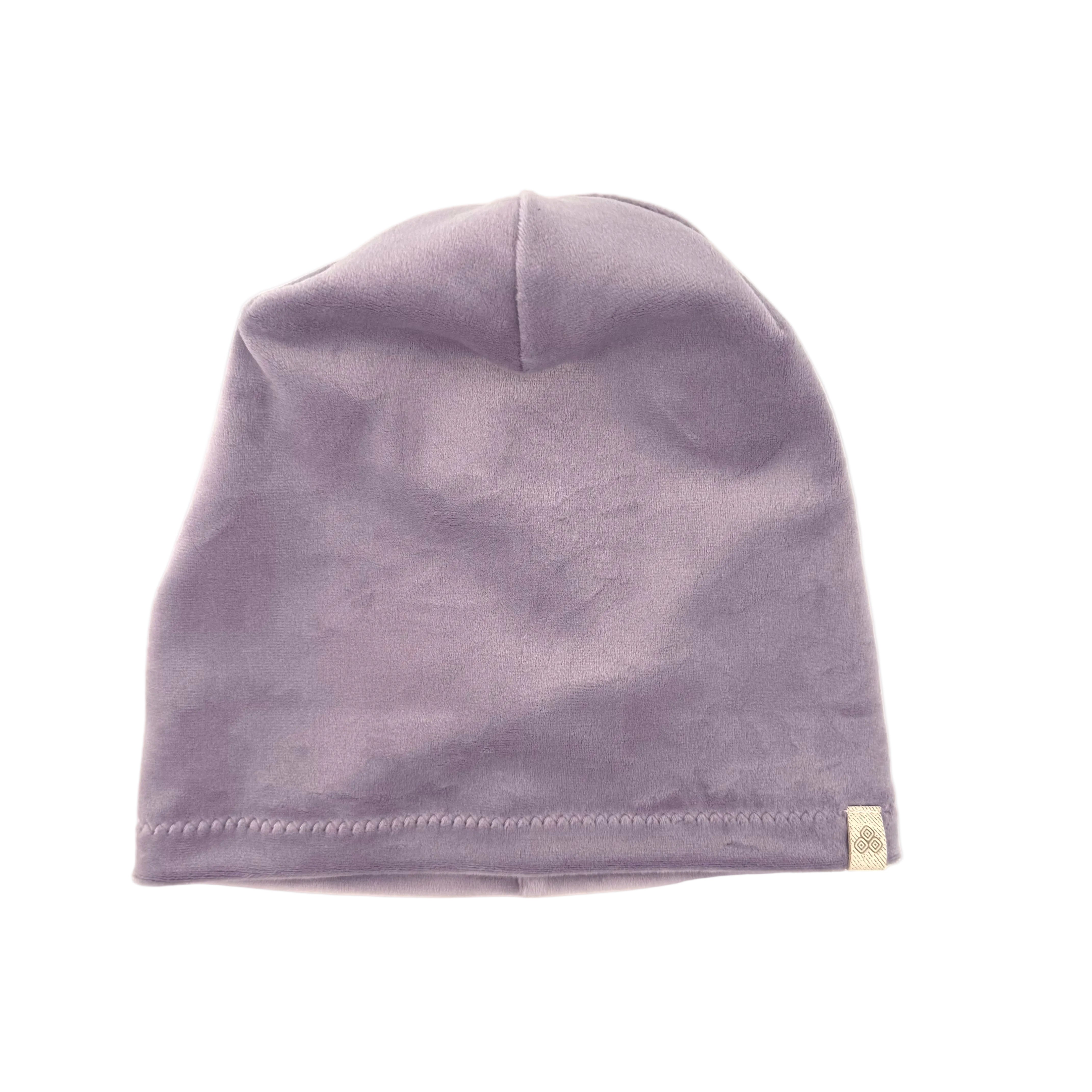 A light purple knit beanie hat with a small beige tag on the side, photographed against a plain white background.