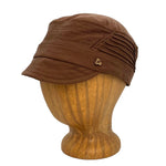 Art Soft Cap in dark orange brown color profile angle on wooden head block – soft cap with coconut button and elastic back