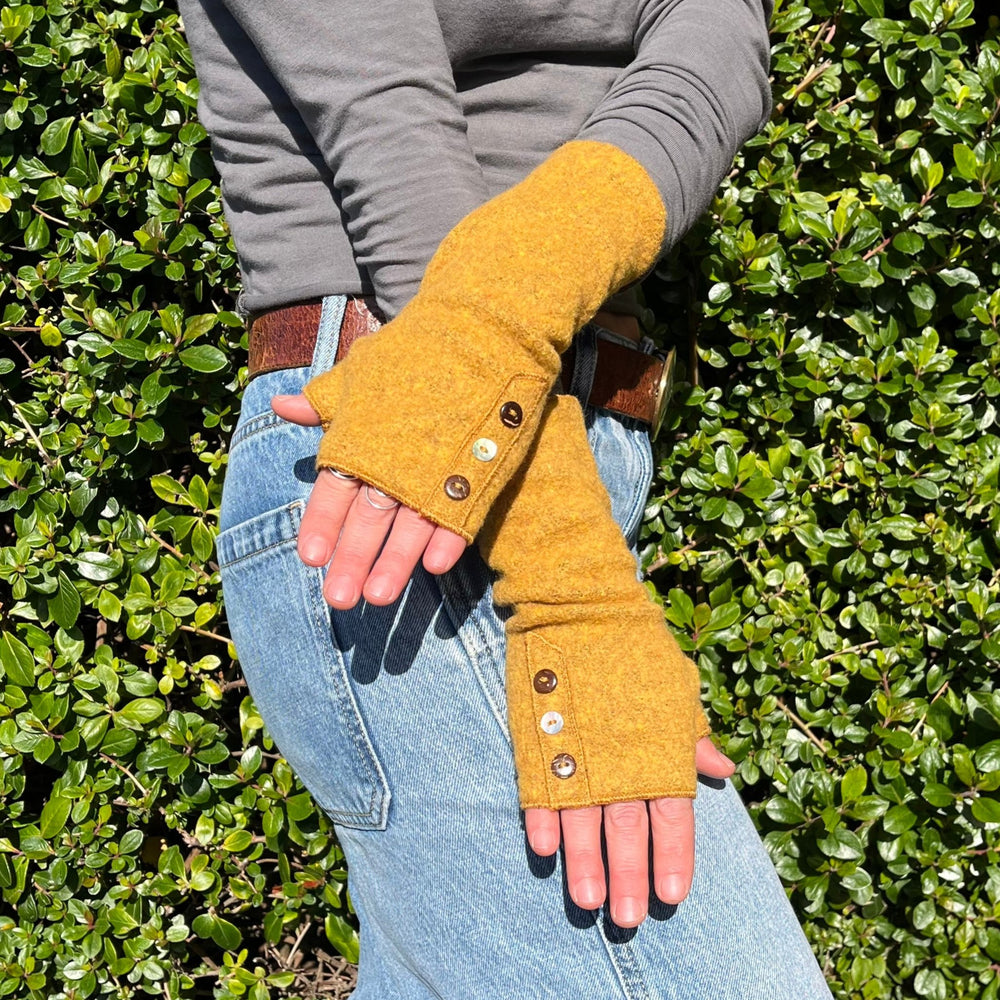 Coco Wrist Warmers in yellow dijon color on female model front view– bohemian sustainable gloves
