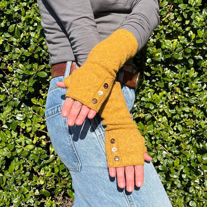 Coco Wrist Warmers in yellow dijon color on female model front view– bohemian sustainable gloves