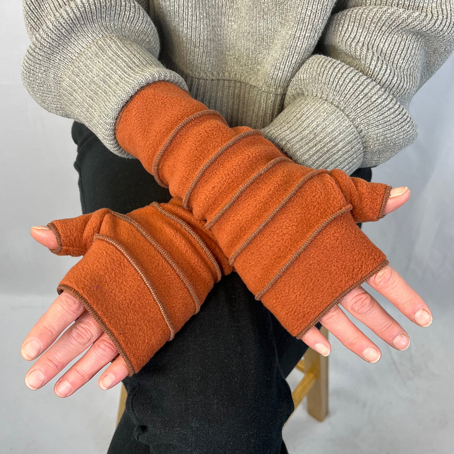 Crossroads Polar Fleece Wrist Warmers – Female Model Wearing – Made in USA - Terracotta color 