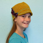 Dalia Kids Soft Cap in yellow dijon color on girl model – recycled cotton fashion