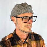 Male model styling the Dublin Flat Cap with casual eco-fashion look.