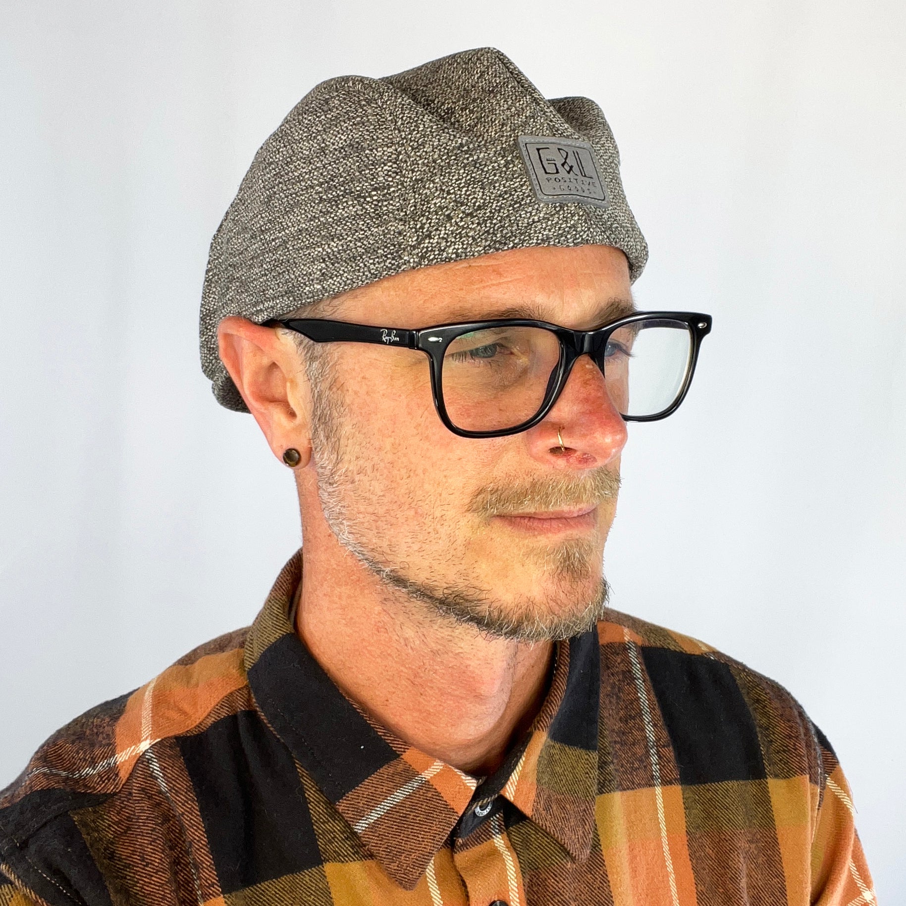 Male model styling the Dublin Flat Cap with casual eco-fashion look.