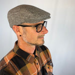 Male model styling the profile of the sustainably made Dublin Flat Cap.