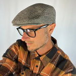 Male model styling the English Ivy Flat Cap with casual eco-fashion.
