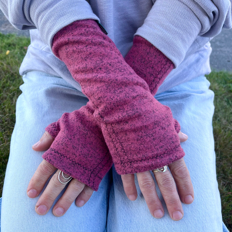 Gemini Wrist Warmers in berry colorway – worn by female model, styled look front