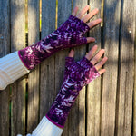 Gemini Wrist Warmers in purple leaves colorway – worn by female model, styled look front
