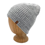 Hemingway Beanie in Flax color – worn on wooden head block.