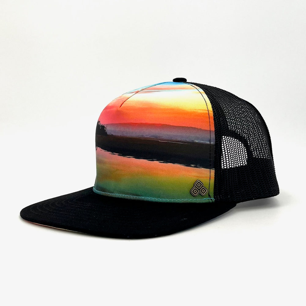 Side profile of the Horizon Trucker Hat, showing its structured fit, eco-friendly materials, and unique sunset photography.