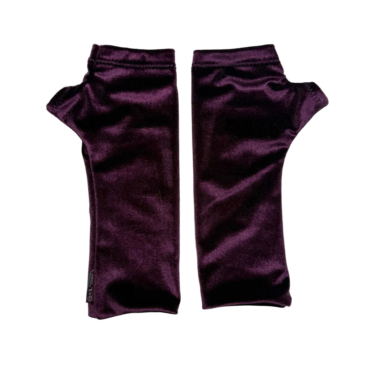 A pair of deep purple velvet fingerless gloves laid flat on a white background.