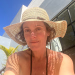 Martinique Sun Hat female model front view made of grass straw with breathable weave and wood bead band