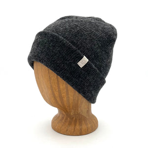 Midnight Beanie in Black color – worn on wooden head block.