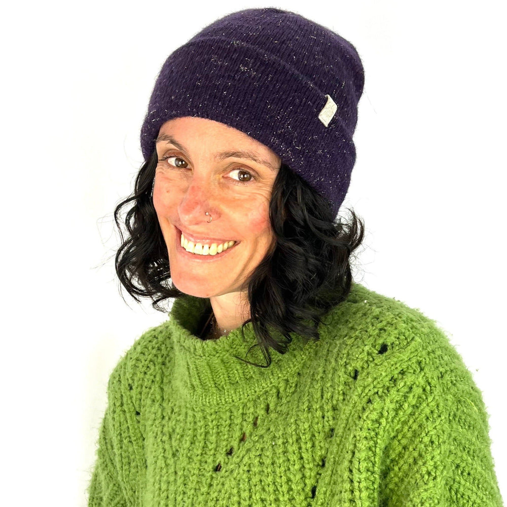 Female model wearing purple Midnight Beanie – eco-friendly knit hat