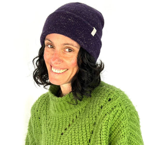 Female model wearing purple Midnight Beanie – eco-friendly knit hat