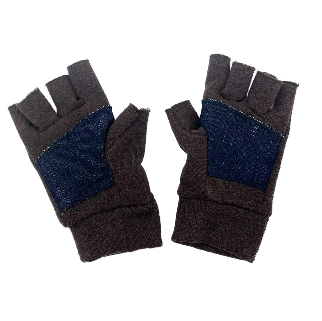 Pair of brown gloves with denim palm on a white background
