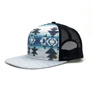 Side profile of the Nu Tribe Grey Trucker Hat, featuring eco-friendly materials and breathable mesh.