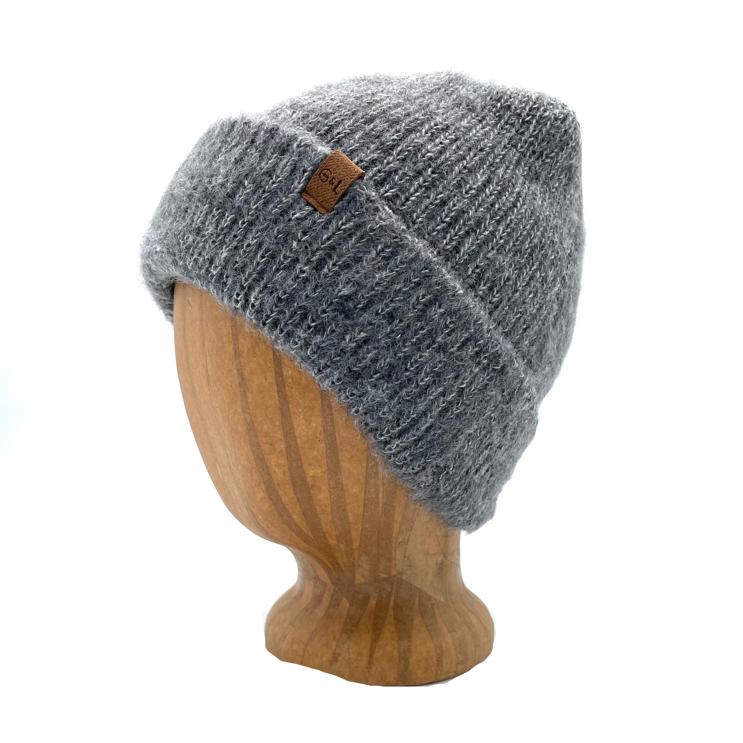 Oaktown Beanie in Graphite color – worn on wooden head block.