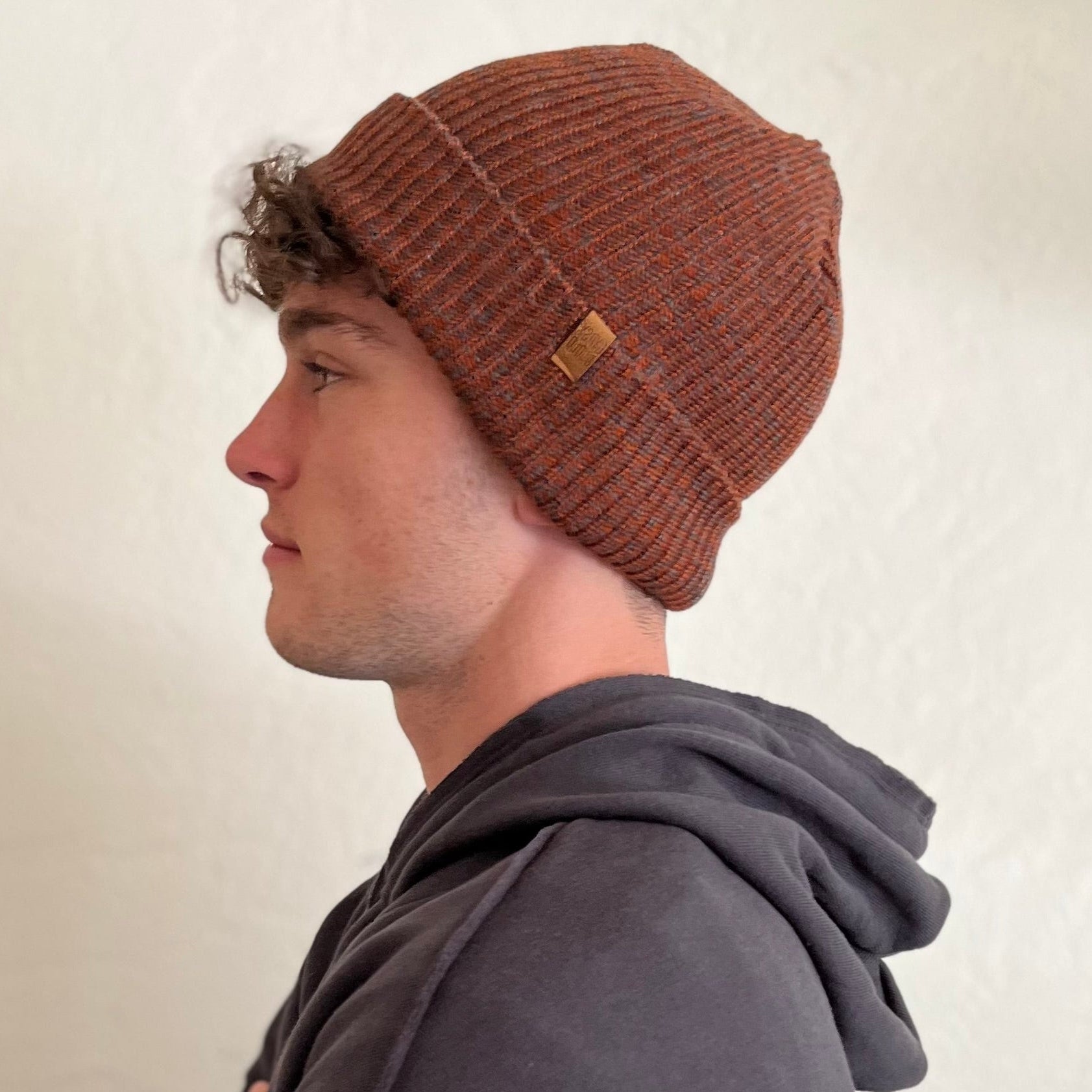 Oaktown Beanie, rust color on male model – sustainable ribbed knit hat