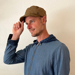 OM Soft Cap in crosshatch yellow umbra colorway on male model – travel-ready upcycled cotton soft cap